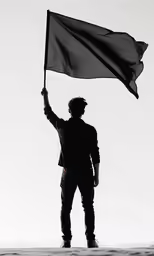a man is holding a black flag up