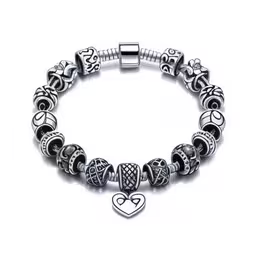 an image of a bracelet that has some hearts on it,silver charm bracelet with two hearts and cross charms