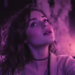 woman in pink light holding up phone to her ear