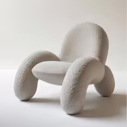 a chair made out of small objects sitting on top of a table