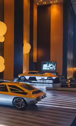 there are three fancy cars parked in the room