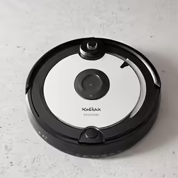a robot vacuum on a white table with a white background