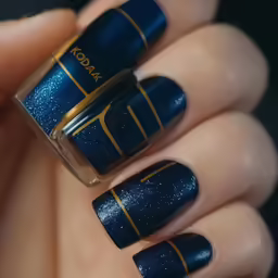 a manicure with a gold striping accent