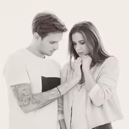 a man and a woman standing close to each other