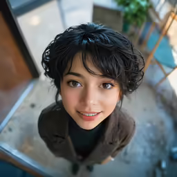 a girl in a brown jacket looks up at the camera