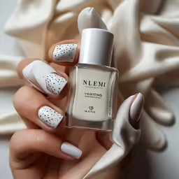 a person holding onto their hands with white and silver nails