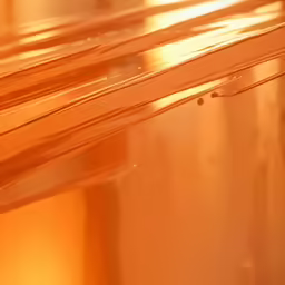the reflection of an orange light on glass