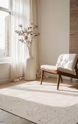 a simple chair sitting in front of a window