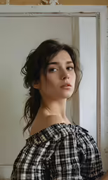 a woman looks into the mirror of a room