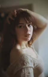 a woman holding her hair near her head