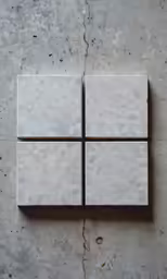 a set of four square pieces of tile