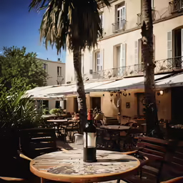 the table is outside of a restaurant with wine
