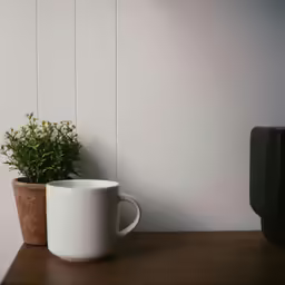 a white mug sitting on top of a wooden table