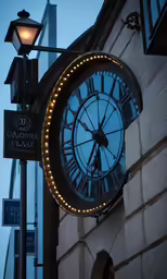 a clock hanging from the side of a building