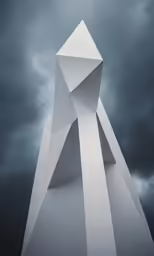 a white sculpture against a cloudy sky