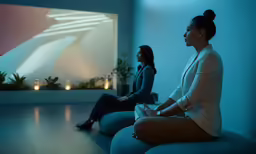 two women sitting and talking together in a room