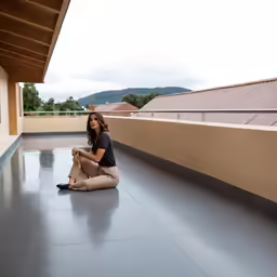 a woman sits on the floor next to her dog