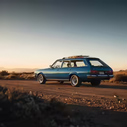 a car is parked on the dirt in the desert