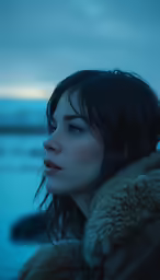 an image of a woman in the snow looking towards the horizon