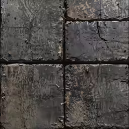 some dark blocks of grey concrete with holes