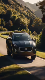 the sporty car drives down a road in the middle of the mountains