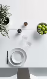 white table top with four small glass dishes and two flower vases