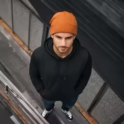 a man standing on top of stairs in a pair of jeans