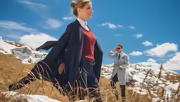 a woman and man wearing trench coats stand in the snow