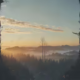 some trees hills and a lot of clouds and sunshine