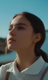 a woman with ponytails wearing white shirt and tan overall