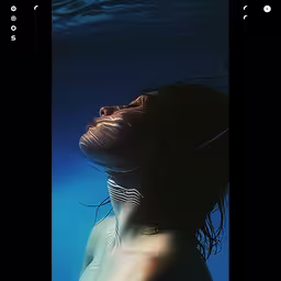 a woman under water in a blue sea,the profile of a woman