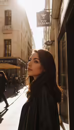 a woman in a black jacket and some buildings