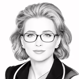 a woman in glasses posing for the camera