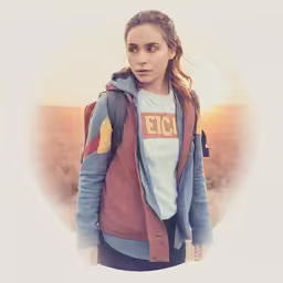 a young woman with a backpack is in the sunlight