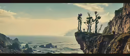 three tall trees on the cliff near the ocean