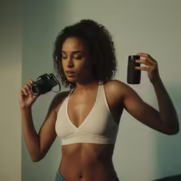 the woman is holding a camera and taking a selfie