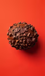 a round object that is on a bright red surface
