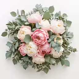 beautiful floral arrangement in pastel colours with green leaves and flowers