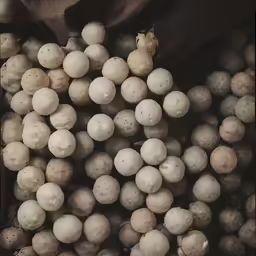 a black cloth covered with snow balls sitting next to it