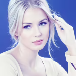 a young blond woman poses for a photo