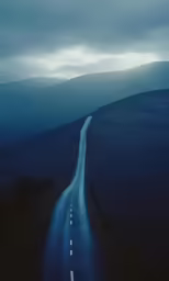a road leading into the distance down into a hill
