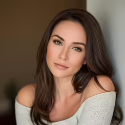 a woman with dark hair and brown eyes is posing for a photo