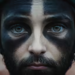 a man with black and white make up on his face