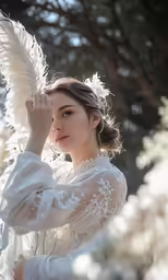 a girl is dressed in white and poses