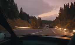 two trucks driving down the highway at night