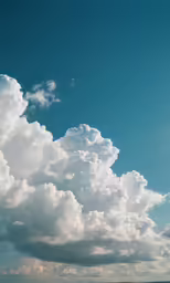 a plane flying over the beach as a lot of clouds gather in the sky