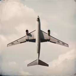 an airplane flying through the air on a cloudy day