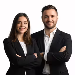 a smiling man and woman in business attire