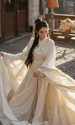 a woman dressed in medieval style clothing walking with white cloth