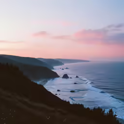 a picture of a beach with the sun setting
